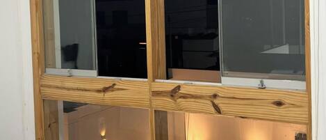 A room with a large sliding glass door leading to a balcony.