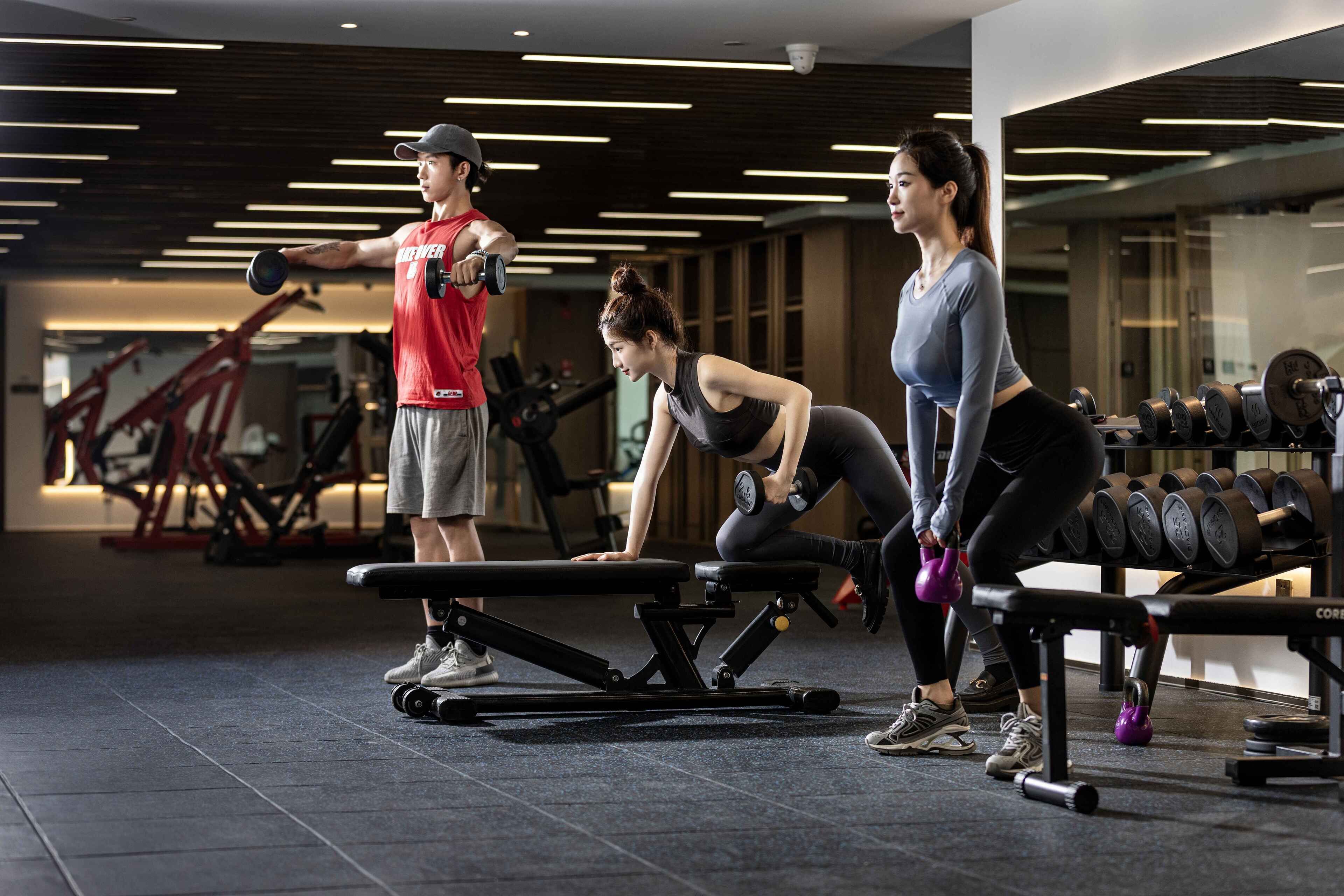 A gym with exercise equipment, including benches and dumbbells.