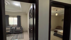 A modern apartment with a living room, a bedroom, and a dining area. - Lamar Taiba Serviced Apartment (Madinah)