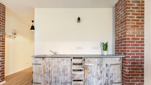 A kitchen with a rustic wooden cabinet, a white countertop, and a small potted plant. - Holiday Apartment 'Hühnerhort' with Shared Terrace, Garden and Wi-Fi (Sankt Annen)