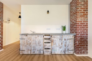 A kitchen with a rustic wooden cabinet, a white countertop, and a small potted plant. - Holiday Apartment 'Hühnerhort' with Shared Terrace, Garden and Wi-Fi (Sankt Annen)