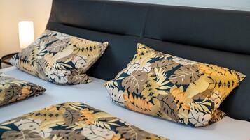 A bed with multiple pillows and a headboard.