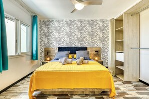 A bedroom with a bed, headboard, bedside tables, and a wardrobe.