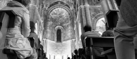 A cathedral interior with high vaulted ceilings and arched windows.