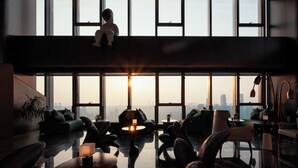 A spacious lounge area with large windows, modern furniture, and a view of the city skyline. - Maiyue Hotel-Chongqing Jiefangbei (Chongqing)