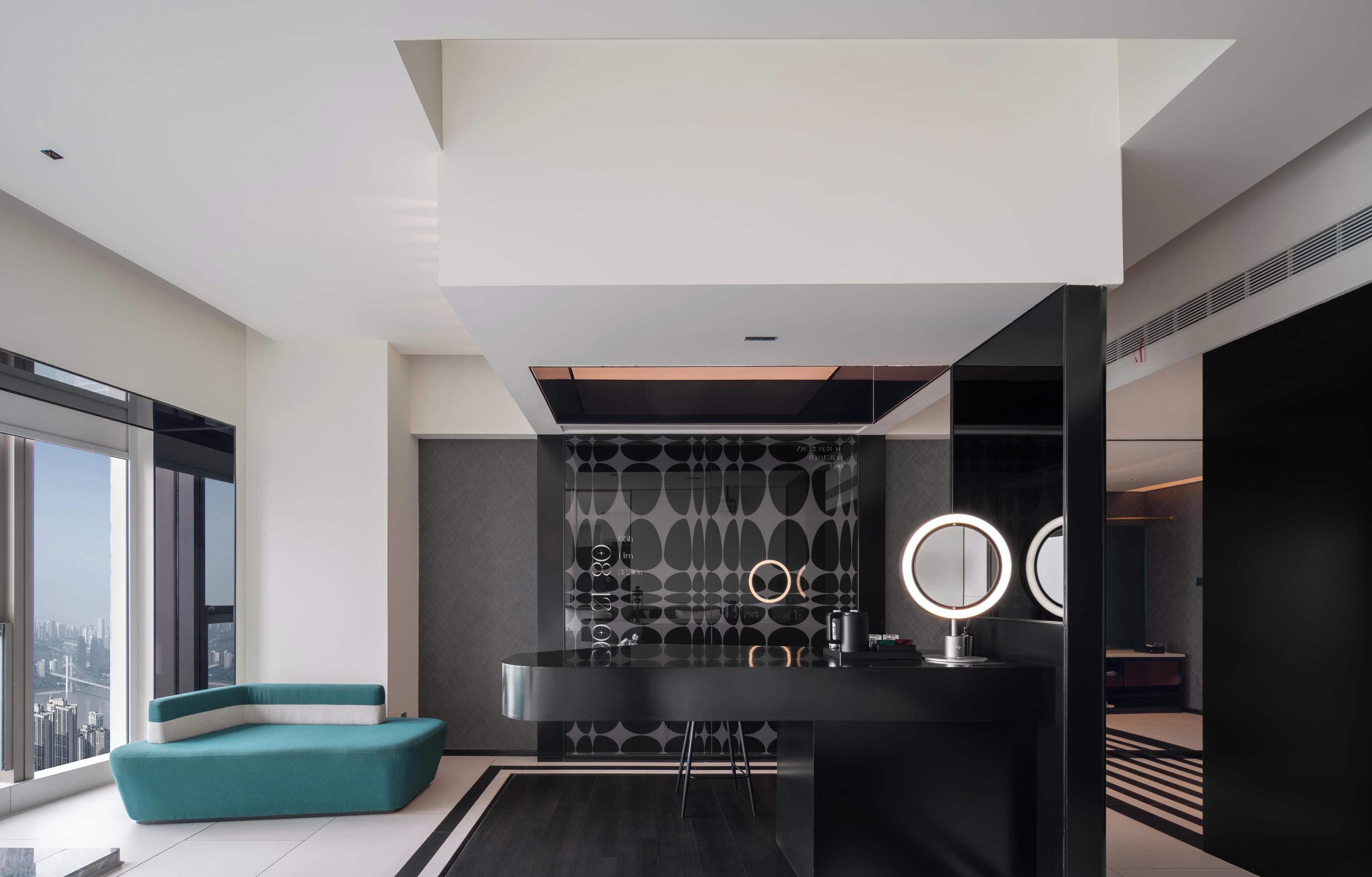 A modern bathroom with a black vanity, two round mirrors, and a patterned wall.
