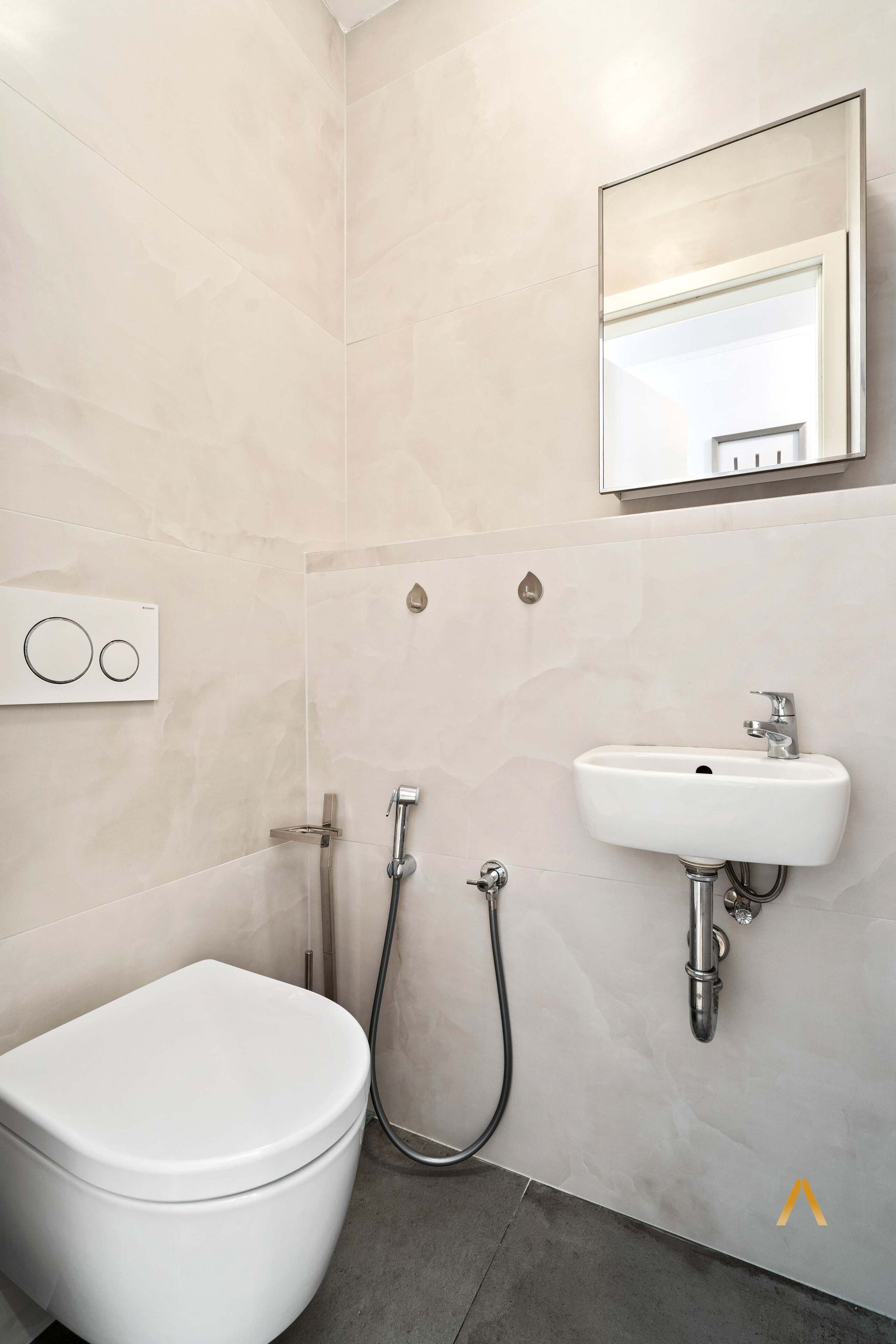 Un baño moderno con inodoro, lavamanos y ducha.