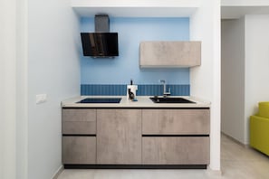 A kitchen with a double sink, a microwave, and a built-in oven.