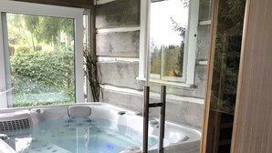 A modern bathroom with a glass-enclosed hot tub, a wooden stool, and a view of the outdoors. - Villa in Tanvald Near Ski Slopes (Tanvald)