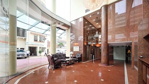 A spacious lobby with a glass facade, a seating area with a sofa and chairs, and a large chandelier. -  Cityview Serviced Apartment & Hotel Ho Chi Minh (Ho Chi Minh City)