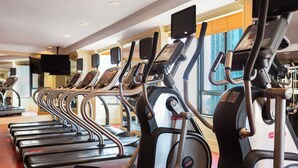 A row of treadmills in a gym with a large window in the background. -  Cityview Serviced Apartment & Hotel Ho Chi Minh (Ho Chi Minh City)