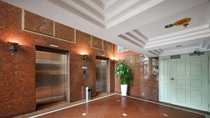 A lobby with two elevators, a trash bin, a potted plant, and a door. -  Cityview Serviced Apartment & Hotel Ho Chi Minh (Ho Chi Minh City)