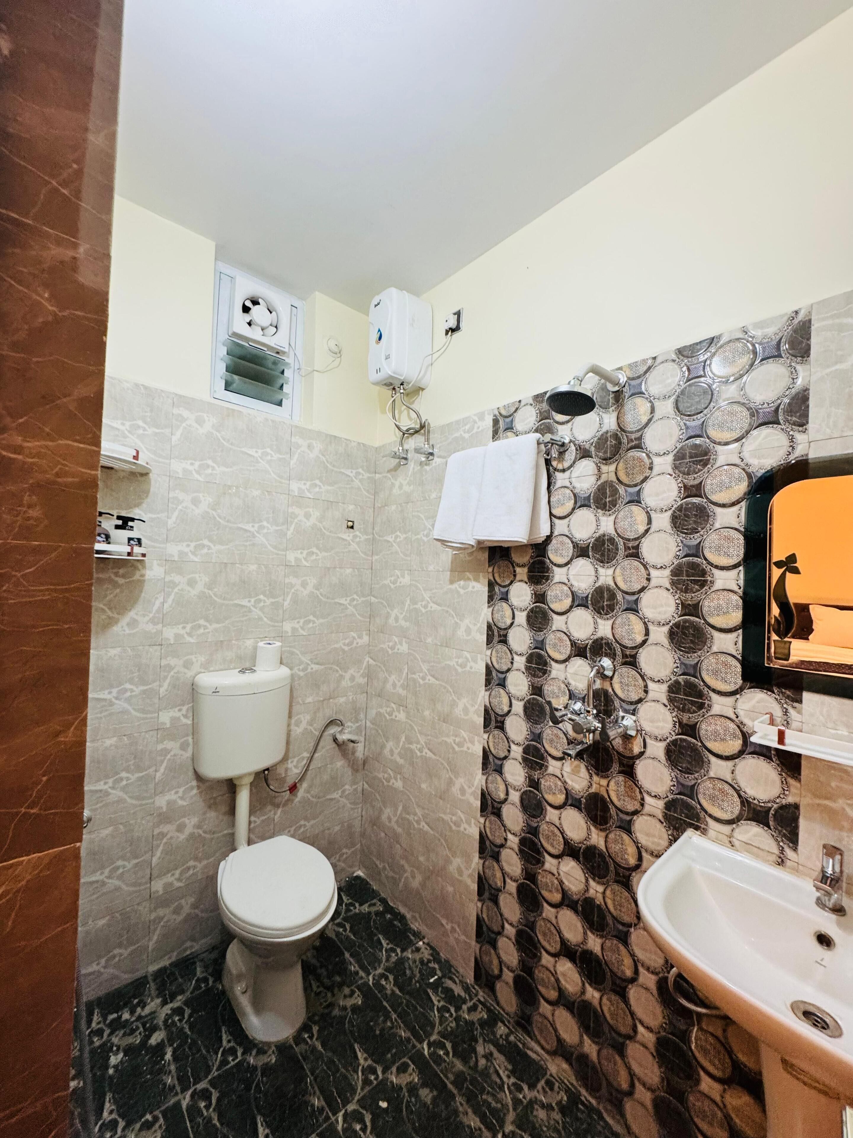 A bathroom with a toilet, a sink, and a shower.