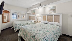 A hotel room with two beds, a TV, a window with blinds, a lamp, and artwork on the wall. - Oceanfront Condo with Resort Pools (North Myrtle Beach)
