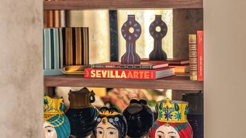 A shelf with books, decorative items, and figurines.