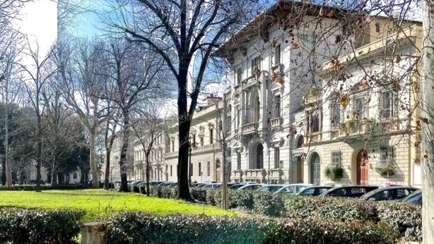 A historic building with classical architecture, a well-maintained lawn, and parked cars. - Charming 2-bedroom apartment in lovely Firenze with AC, WiFi (Florence)