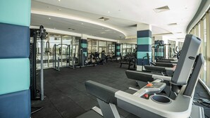 A modern gym with various exercise equipment, including treadmills and weight machines.