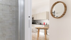 A modern kitchen with white cabinets, a microwave, and a coffee machine. - Palazzo Murat - Apartment With City View by Wonderful Italy (Bari)