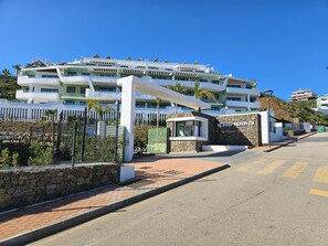 A multi-story hotel with a modern design, featuring balconies and a stone facade. - Ipanema near La Cala de Mijas (Mijas Costa)