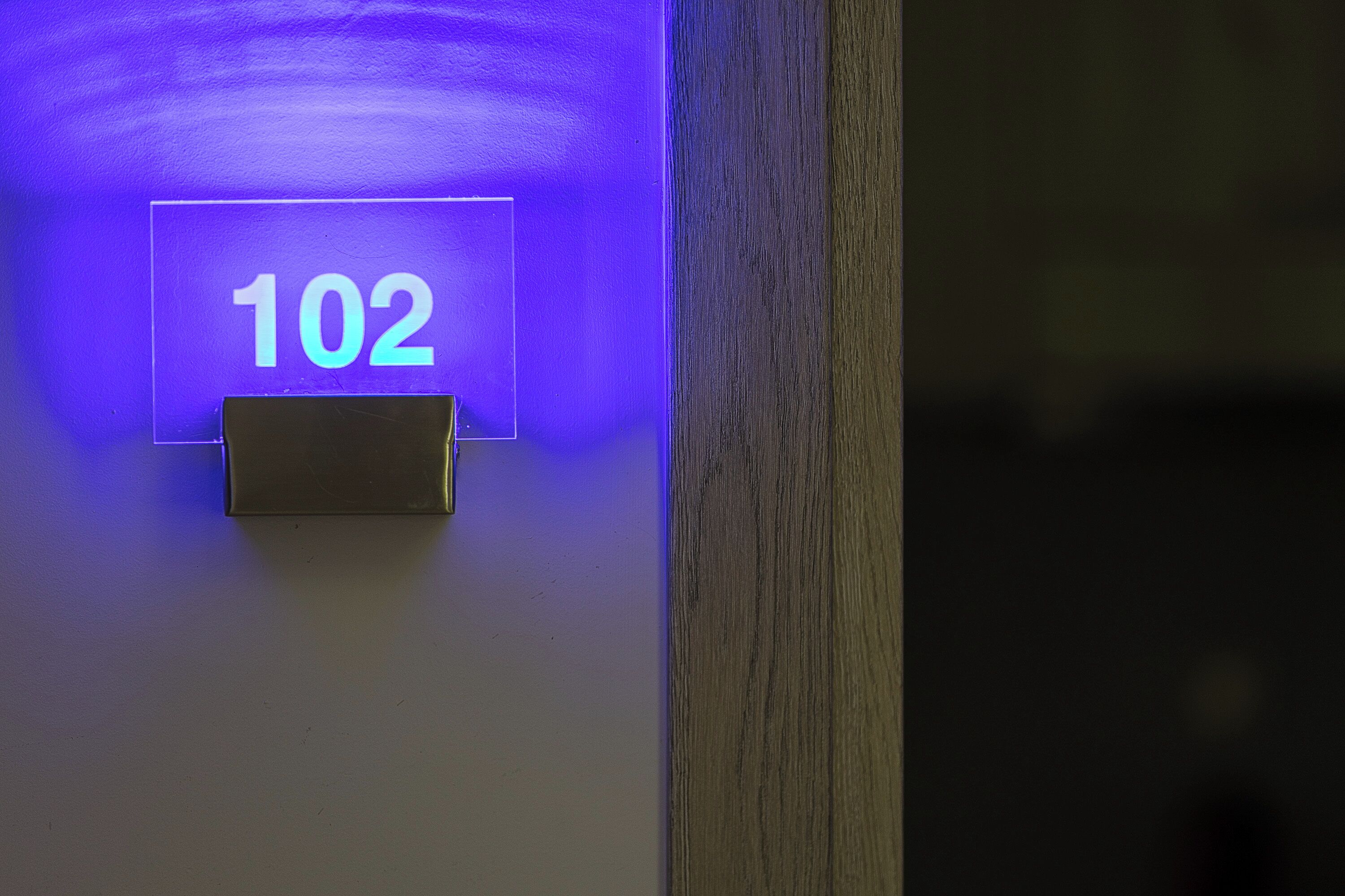 A door with a number sign indicating room 102.