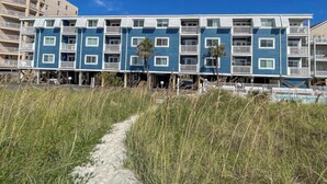 A beachfront hotel with multiple floors, balconies, and a clear sky. - 10% off 3-7 nights thru Dec. 2BR 2BA oceanVIEW condo Cherry Grove. Peaceful area (North Myrtle Beach)