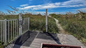 A pathway leading to a beach area with a white fence and a metal gate. - 10% off 3-7 nights thru Dec. 2BR 2BA oceanVIEW condo Cherry Grove. Peaceful area (North Myrtle Beach)