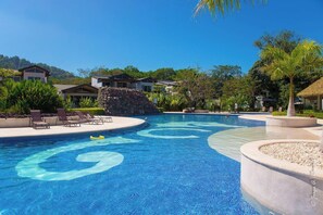 A swimming pool with a circular design, lounge chairs, and a thatched-roof structure. - Comfort and Relax in Ciudad Mar with private pool (Jacó, Ciudad del Mar)