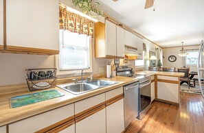 Dishwasher, coffee/tea maker, cookware/dishes/utensils, dining tables