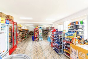 Convenience store with shelves stocked with snacks, beverages, and grocery items.