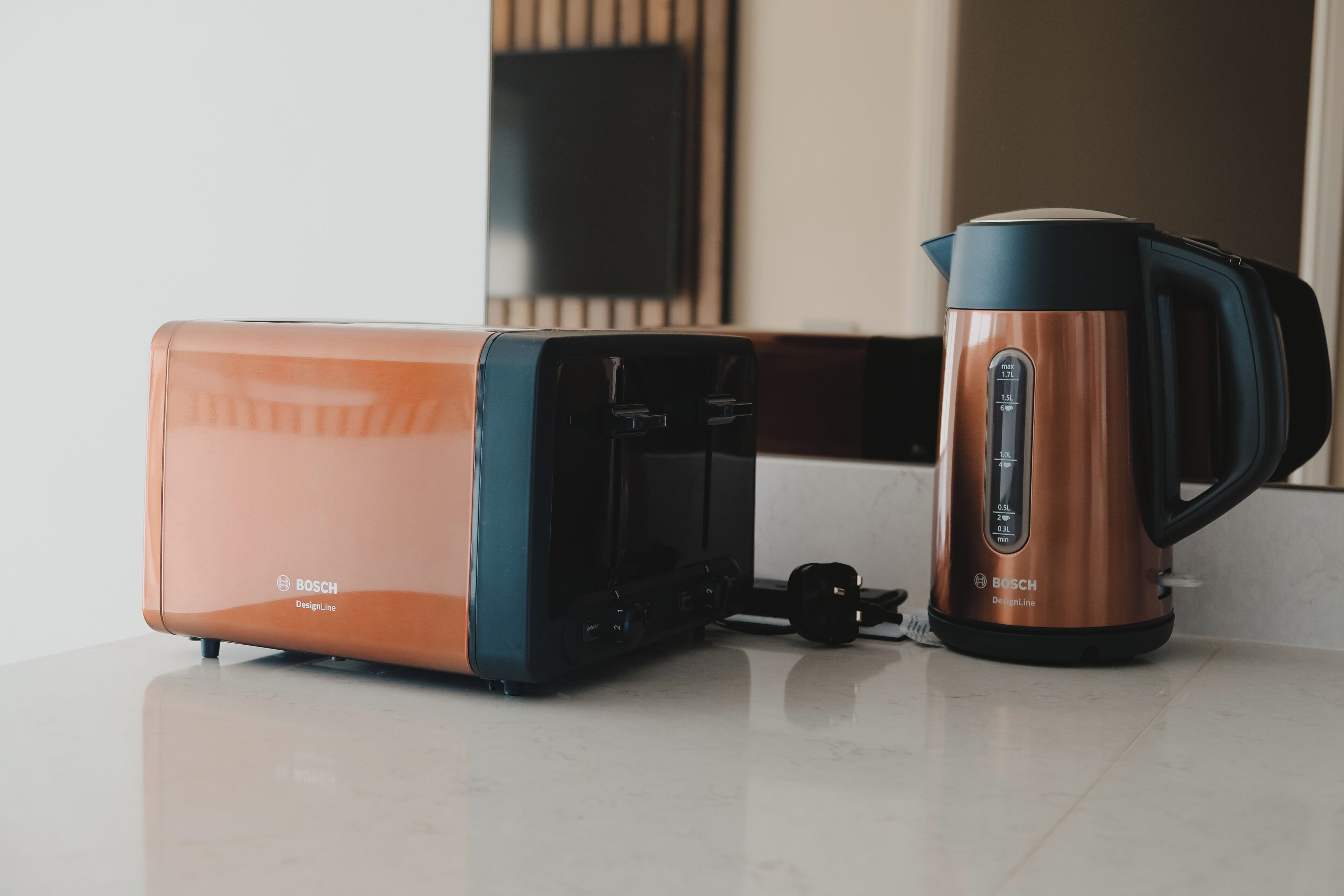A kitchen with a toaster and a coffee maker on a countertop.