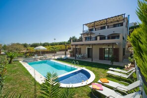 A two-story house with a swimming pool, outdoor seating, and a garden. - Villa Orsalia With Private Pool (Rethymno)