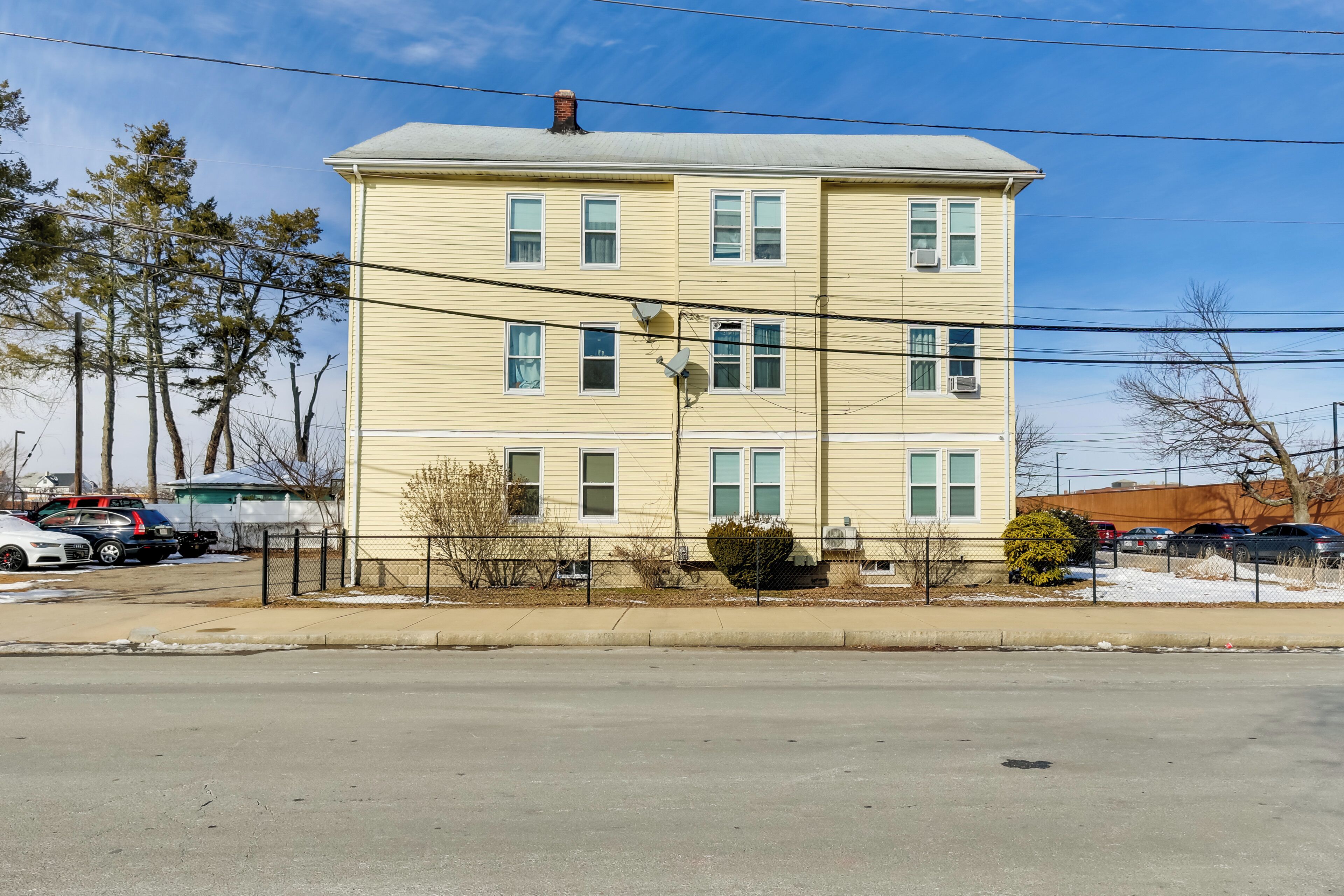 A two-story building with multiple windows and a flat roof.