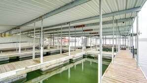 A covered marina with multiple docks and boats. - Private Boat Dock: Lakefront Cabin in Camdenton (Camdenton)