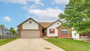 A two-story house with a garage, a brick exterior, and a well-maintained lawn. - 17 Mi to Columbus: Pickerington Home w/ Fire Pit! (Pickerington)