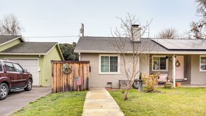 A residential house with a garage, a front yard, and a driveway.