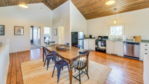 A spacious kitchen with wooden floors, white cabinets, and modern appliances. - Countryside Barndominium in Virginia w/ Patio (Louisa)
