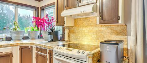 A kitchen with wooden cabinets, a built-in oven, a microwave, and a toaster.