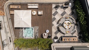 An outdoor patio with seating, a hot tub, and a dining area. - Luxury Rooftop Jacuzzi Penthouse at Savoy Insular (Funchal)