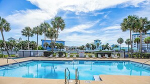 A swimming pool with a no diving sign, surrounded by palm trees and lounge chairs. - New Listing! Beach Vibe Is Only A Boardwalk Away From The Gulf! (Pensacola)