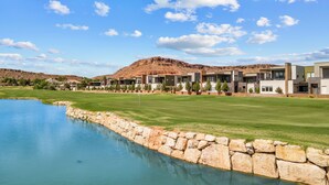 A modern resort with a pool, green lawns, and a mountain backdrop. - Villa #19 at Bloomington Country Club: Pool, Golf, Restaurant (St. George)