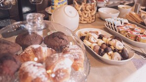 A buffet with various pastries and desserts, including cookies, muffins, and fruit tarts. - LA GELSOMINA (Mascali)