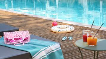 Seasonal outdoor pool, open 8:30 AM to 8:00 PM, pool umbrellas