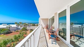 A balcony with a view of the ocean, furnished with chairs and a table. - Dunes B206-King Bed-Tennis/Pickleball-Pet Ok (Panama City Beach)