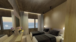 Une chambre d’hôtel moderne, dotée de deux lits, d’un bureau et d’une grande fenêtre donnant sur l’océan.