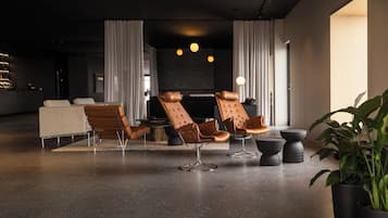 A modern lounge area with leather chairs, a sofa, and a coffee table.
