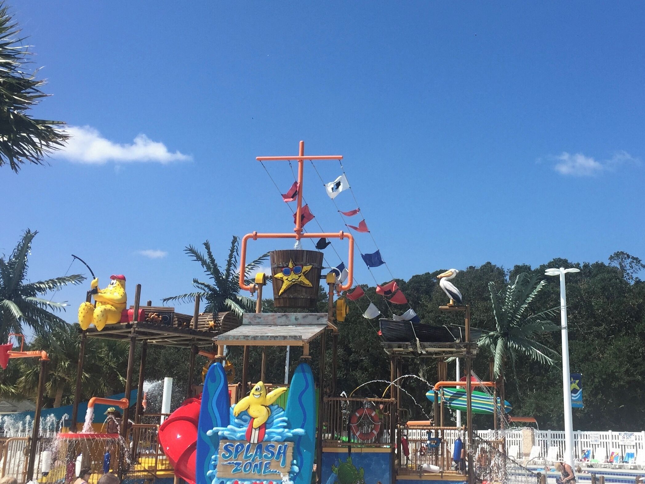 A water park with a splash zone, slides, and various water features.