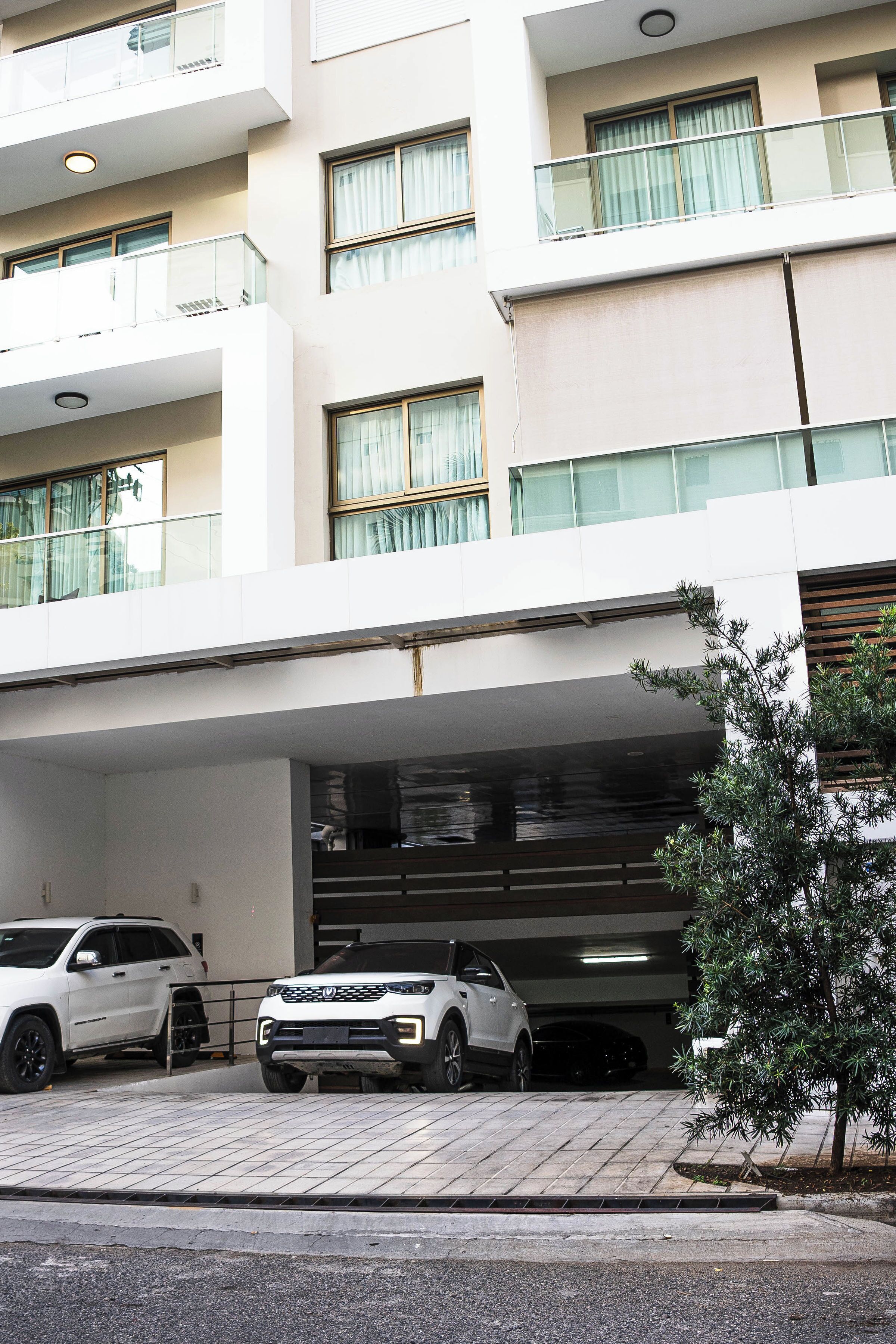 A multi-story building with a parking garage.