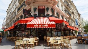 A café with outdoor seating and a red striped awning. - 18TH-CENTURY PALACE, BLEND OF OLD-WORLD GRANDEUR & MODERN COMFORT - LE MARAIS (Paris)