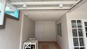 A covered patio area with a white ceiling, a door, and a tiled floor. - Relaxing Escape in Hua Hin City 94/2 (Tambon Hua Hin)