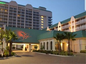A hotel with a large building, multiple balconies, and a prominent logo on the facade. - Oceanfront Cozy condo w/private balcony, kitchen, pool, fitness center, beach  (Daytona Beach)